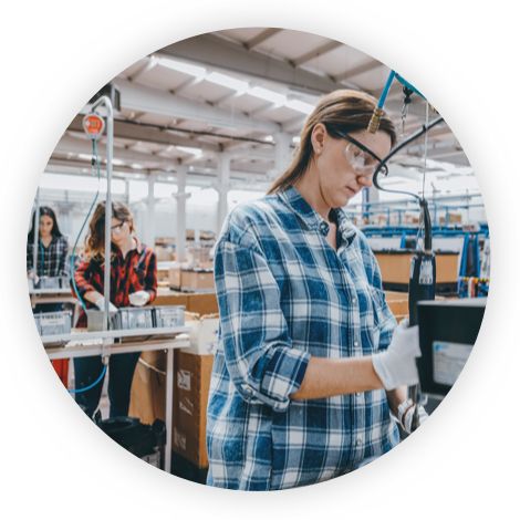 Workers standing at their desk in a warehouse concentrating on what they are doing