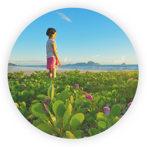 A girl standing among flowers